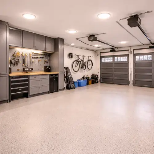 Remodeled garage with clean flooring and organized workspace