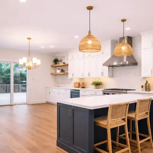 Clean kitchen renovation with island and wood flooring